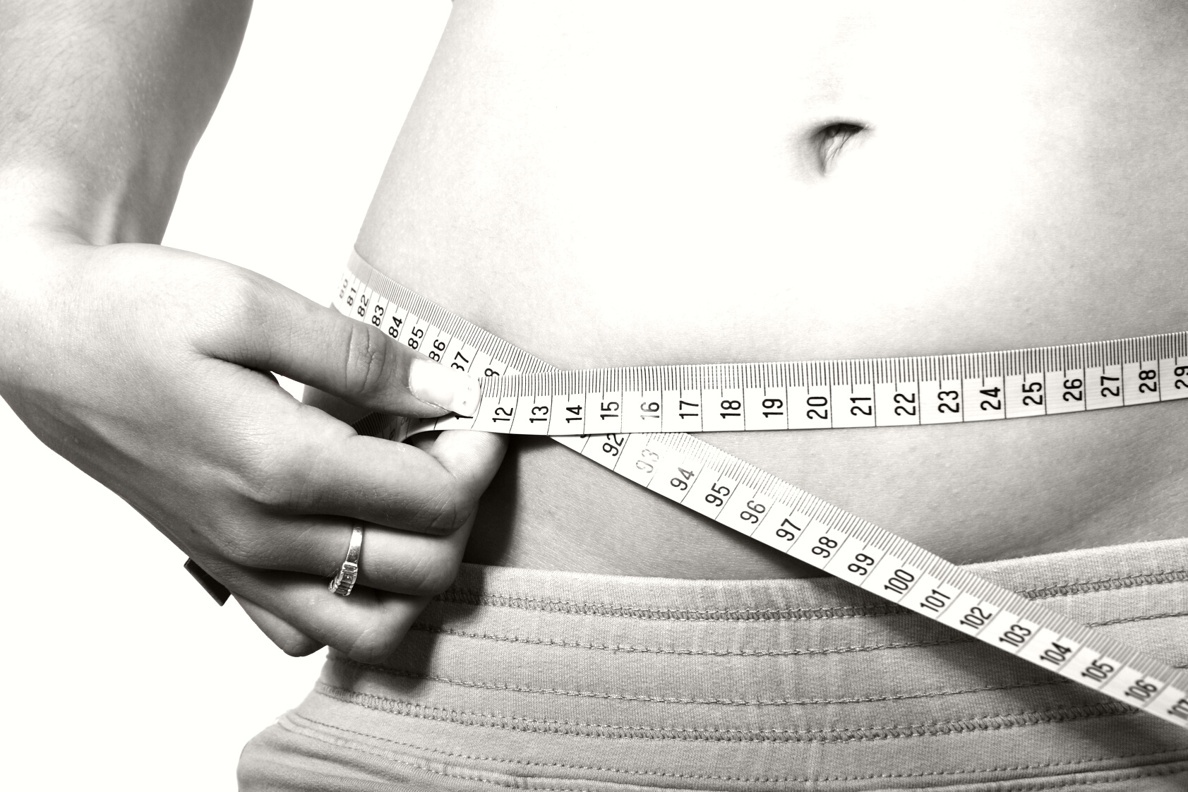 Woman Holding Measuring Tape on Hips