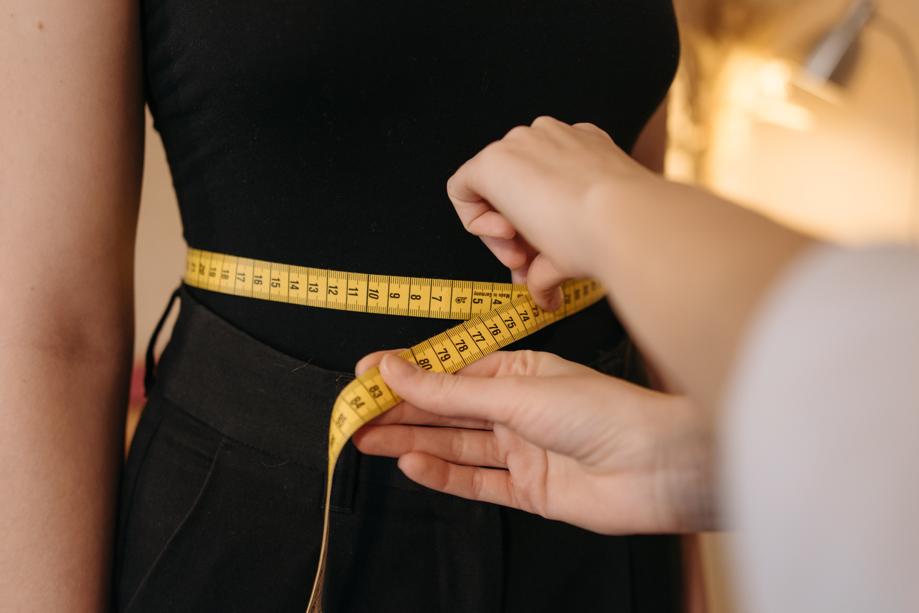 A Person Using a Measuring Tape